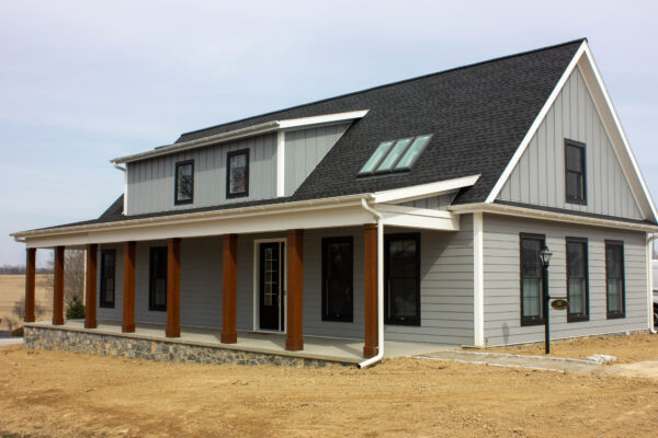 Gray house with white trim and chestnut brown column wraps